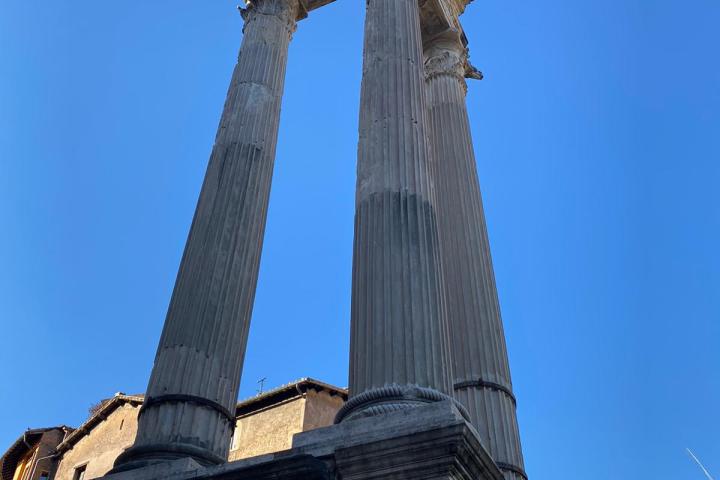 a large tall tower with a clock on the side of a building