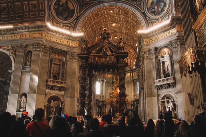 a group of people standing in front of St. Peter's Basilica