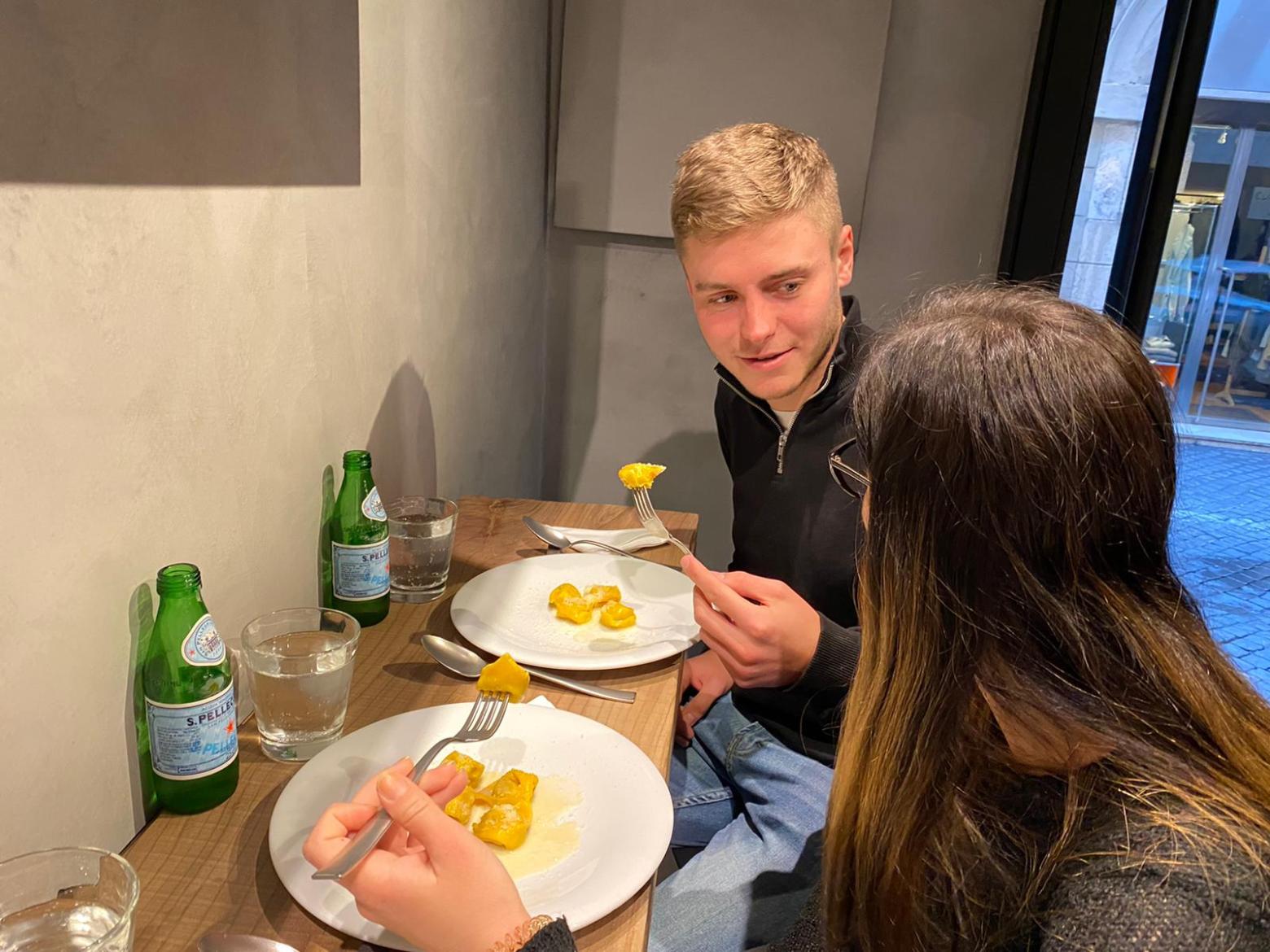 a person sitting at a table eating food