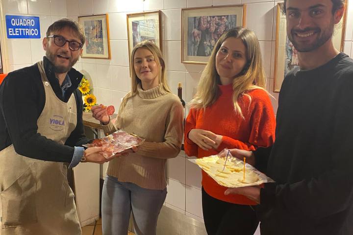 a person standing in front of a group of people posing for the camera