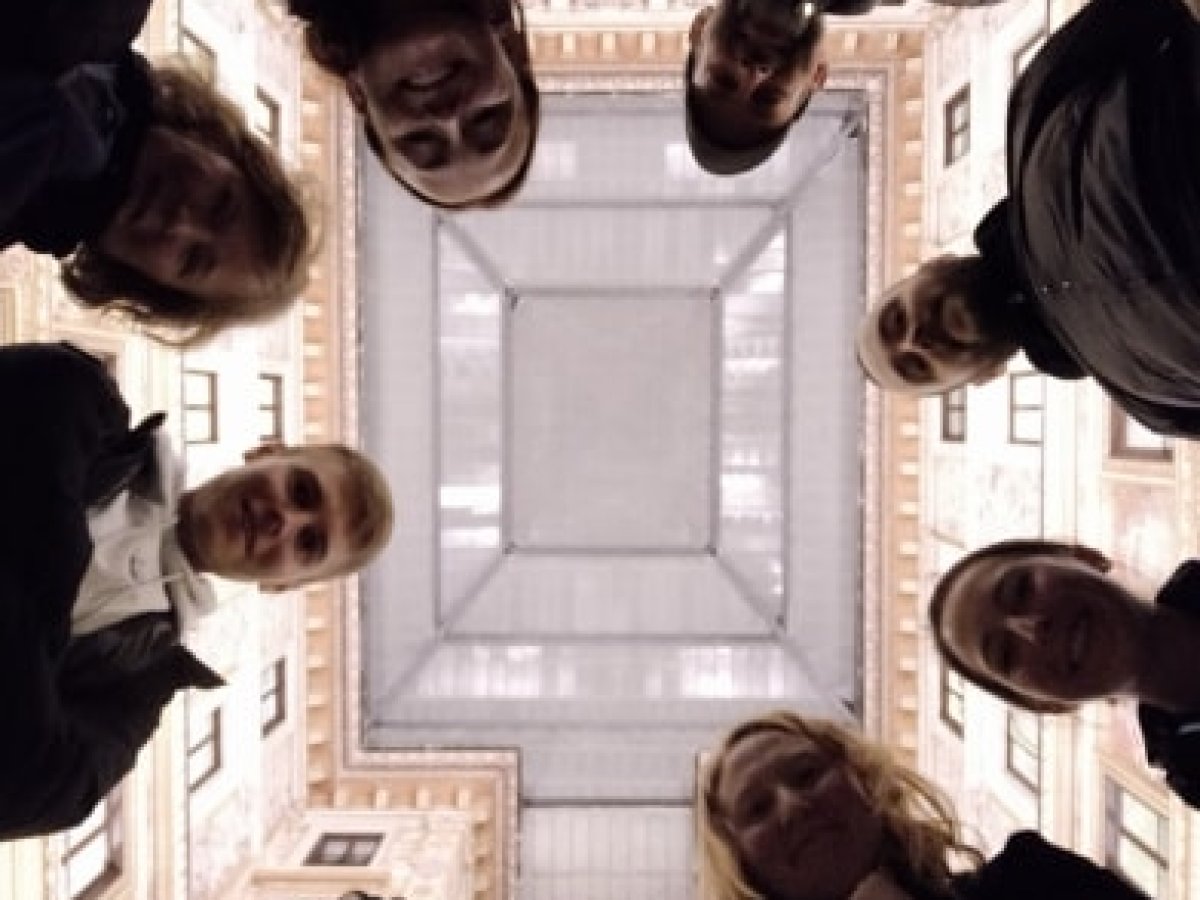 a group of people standing in front of a mirror