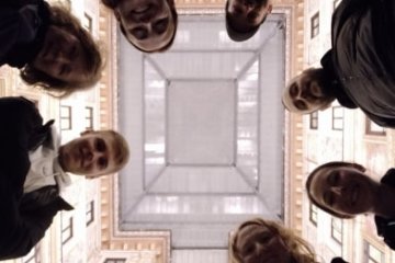 a group of people standing in front of a mirror