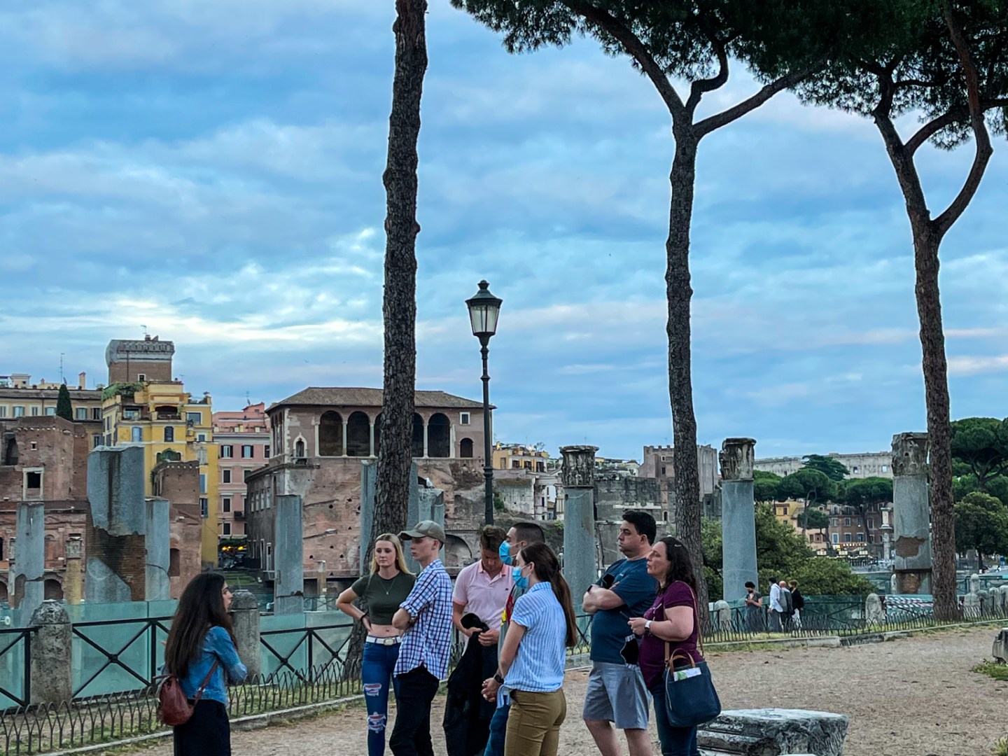 a group of people standing in front of a tree