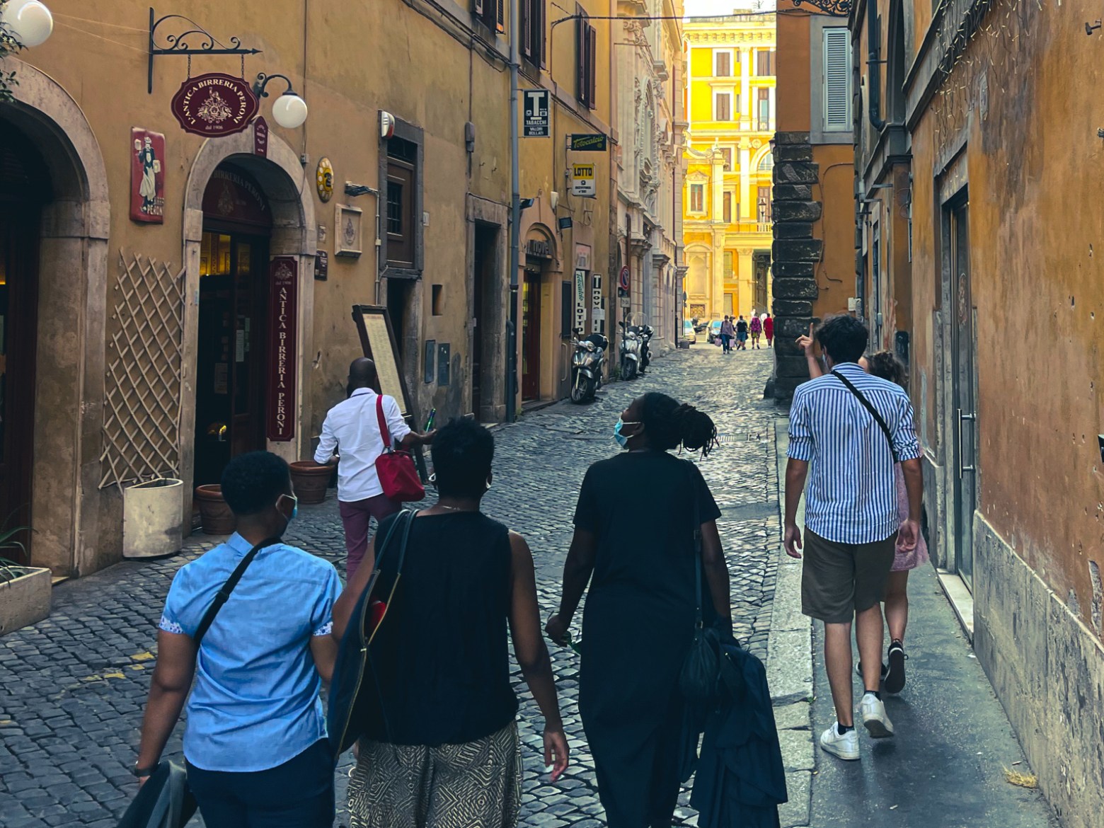 a group of people walking on a city street