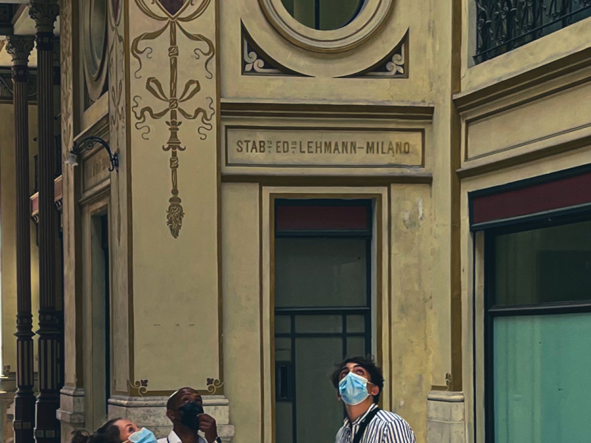a person walking down a street in front of a building