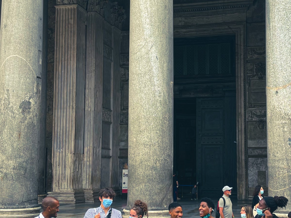 a group of people standing in front of a building