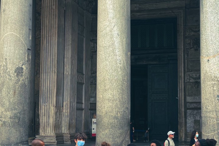 a group of people standing in front of a building